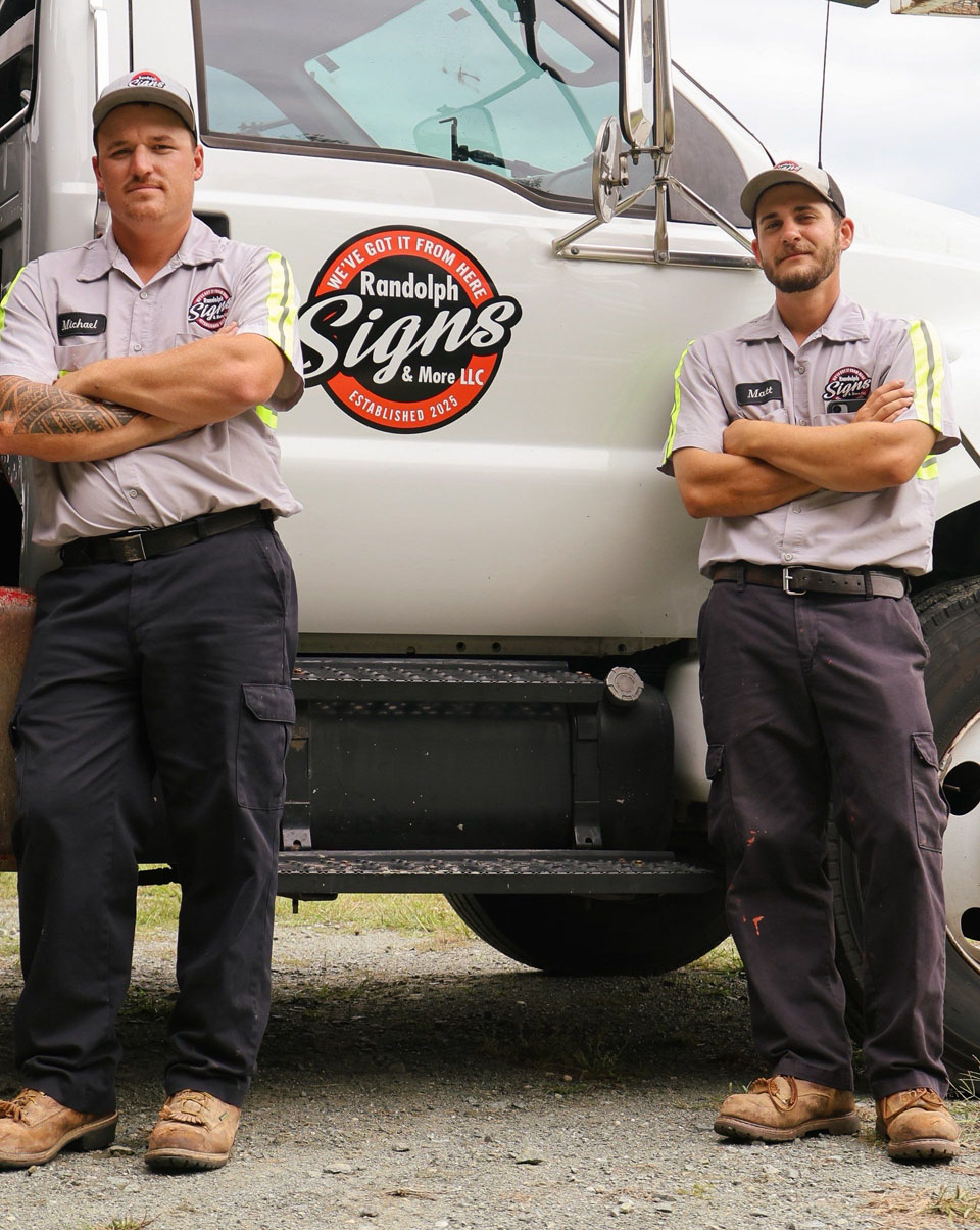 Randolph Signs family team with bucket trucks